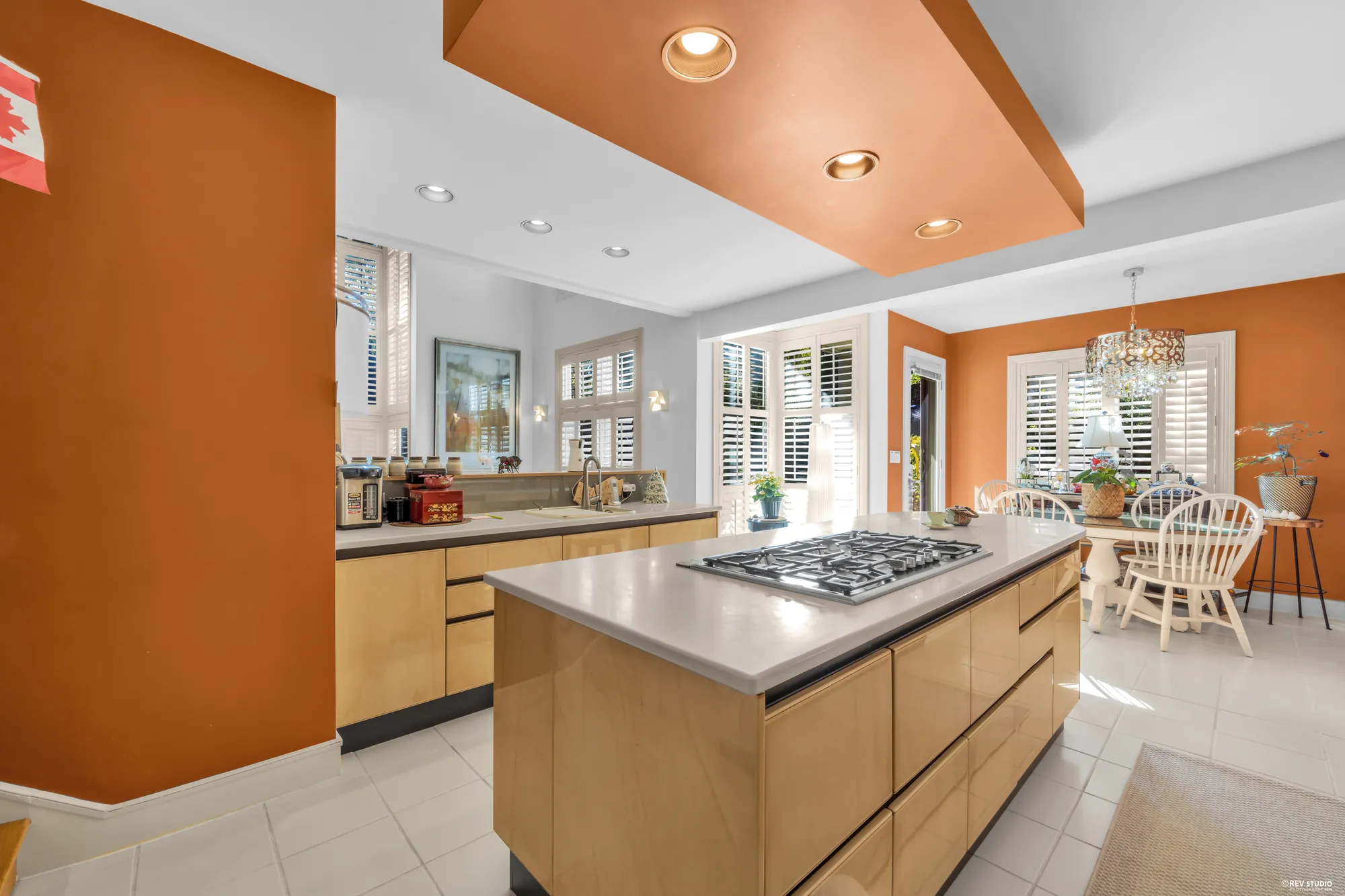 The kitchen from the nook: the island, the terracotta wall, the tile floor